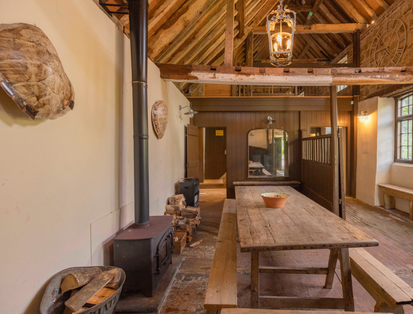 Inside of Mountfield Winery's tasting room showing the wooden seating and vaulted ceiling