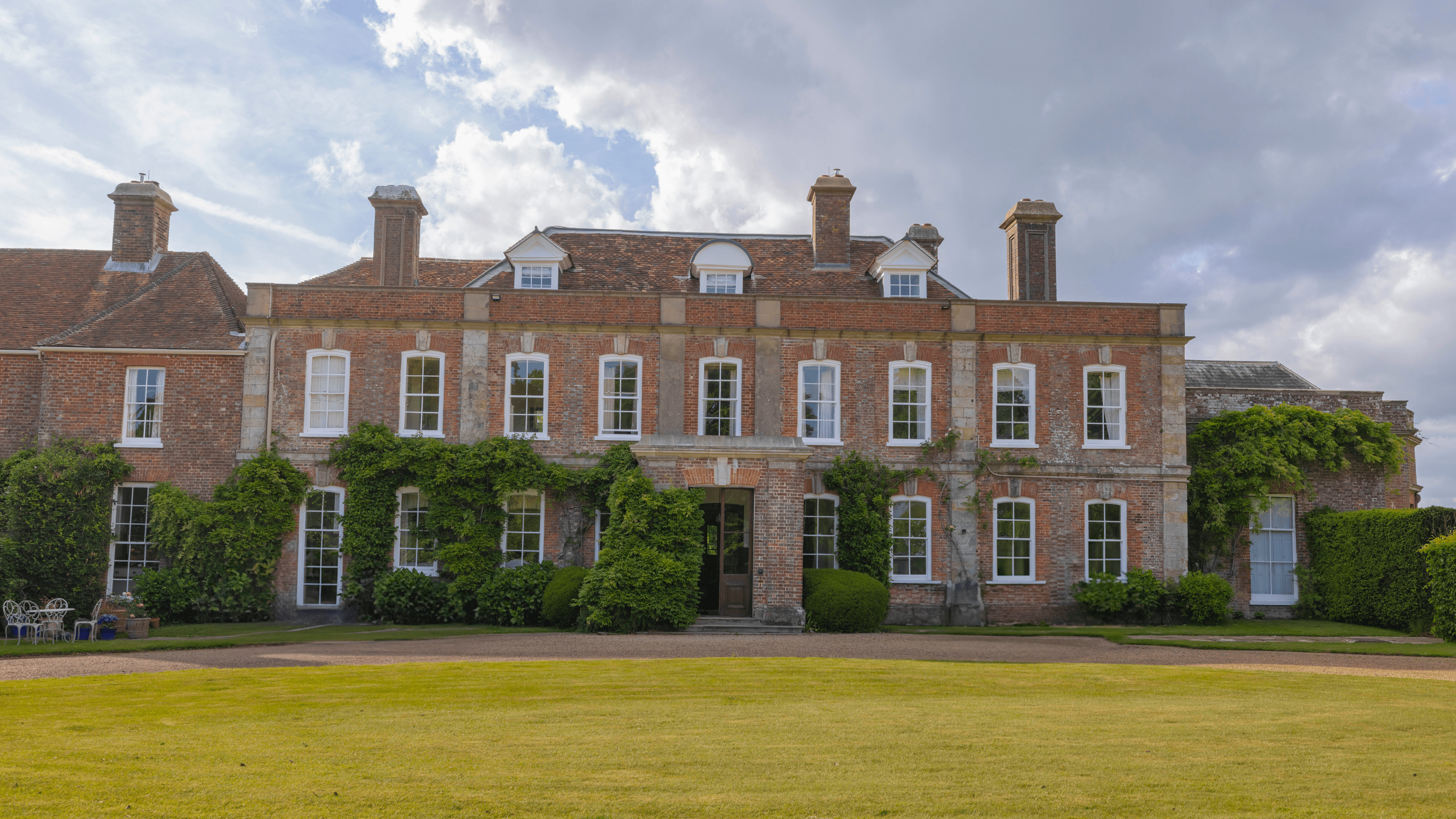 The front elevation of the manor house with the front lawn and driveway at Mountfield Winery