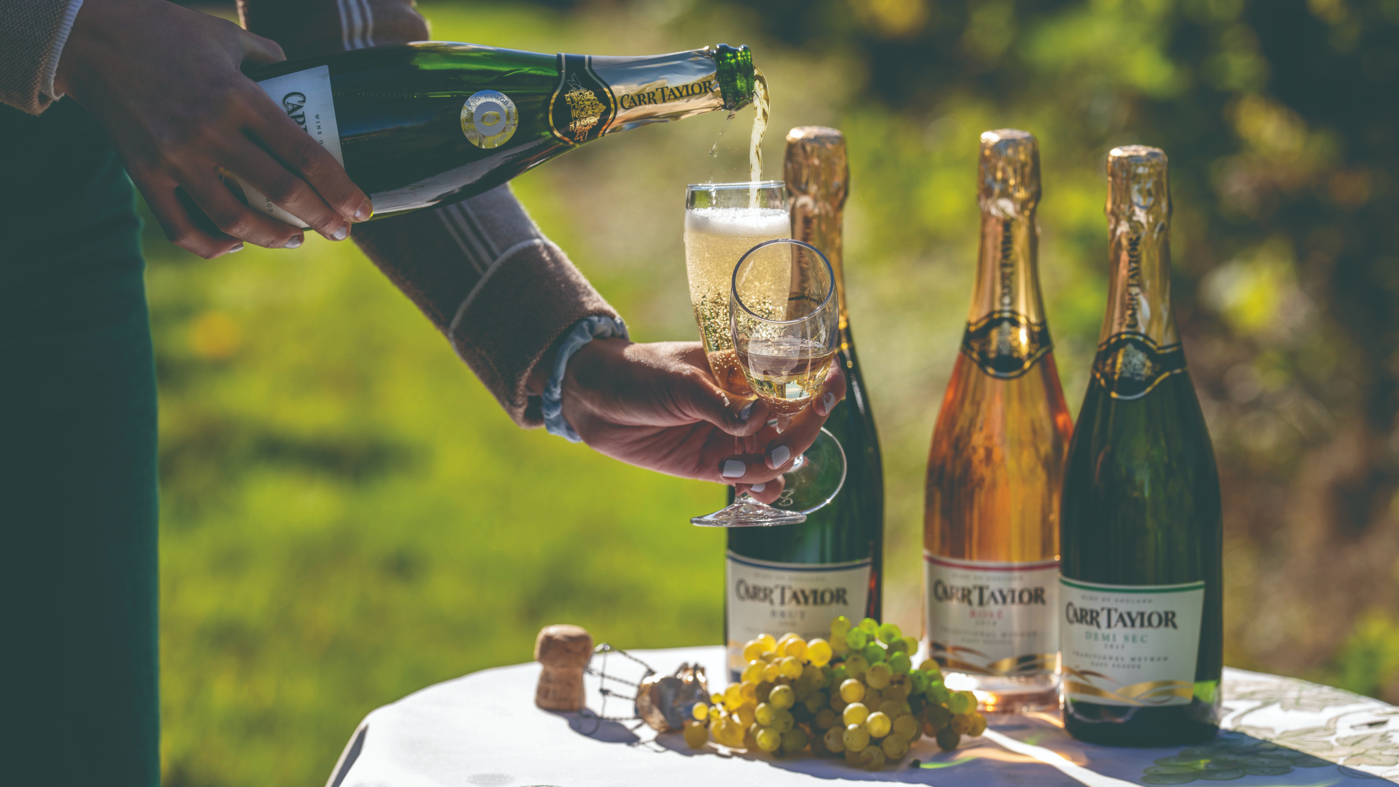 A glass of sparkling wine being poured at Carr Taylor Wines