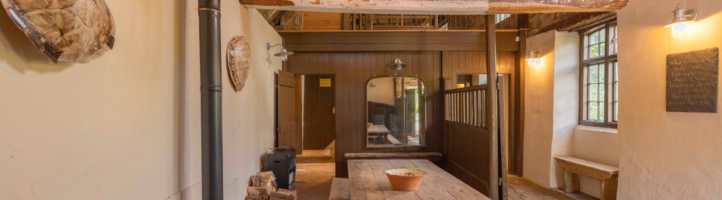 Inside the tasting room with wooden benches and tables at Mountfield Winery